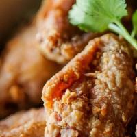 Thai Crispy Chicken Wings · Golden crispy marinated chicken wings, served with house chili sauce.