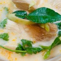 Tom Kha Soup · Coconut soup with cabbage, lemongrass, kaffir lime leaves, mushroom onion, tomatoes, cilantro.