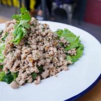 Larb Kai · Minced chicken sautéed and tossed in a lime dressing with mint leaves, cilantro, onion, toas...