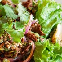 Larb Mock Duck · Vegetarian. Crispy mock duck sautéed and tossed in lime dressing with toasted rice powder, c...