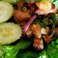 Larb Moo Kob · Crispy pork belly sautéed and tossed in lime dressing with toasted rice powder, chili powder...