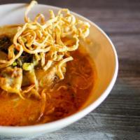Khao Soi · A Burmese influenced dish served widely in Northern Thailand, with a curry soup base, chicke...