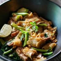 Pad See Ew · Wide rice noodles stir fried with an egg, dark soy sauce and Chinese broccoli.