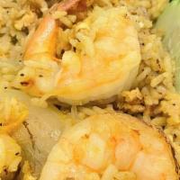 Pineapple Fried Rice · Stir-fried jasmine rice with chicken, shrimp, egg, raisins, cashews, onions,peas, carrots, a...