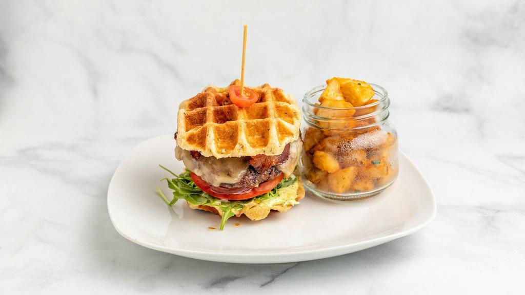 We Found The Beef · Grass fed natural beef patty, cherrywood smoked bacon, white Cheddar, savory onion jam, arugula, tomato, shaved onion, basil aioli, fresh herb waffle.