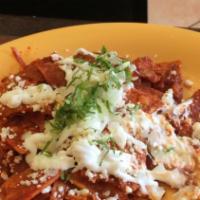 Chilaquiles · Homemade chips smothered in red or green salsa topped with sour cream, queso fresco. with ri...