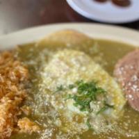 Huevos Rancheros · Two over medium eggs smothered in homemade red or green salsa served with rice and beans.
