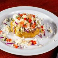 Sopes · Topped with refried beans, cabbage, queso fresco, sour cream, and pico de gallo.