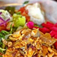 Chicken Shawarma · Slices of marinated chicken slowly cooked on an upright spit. All entrees are served with Ga...