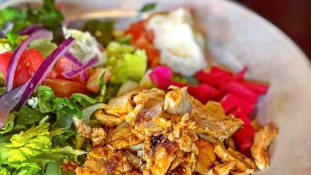Chicken Shawarma · Slices of marinated chicken slowly cooked on an upright spit. All entrees are served with Gaby's house salad and rice.