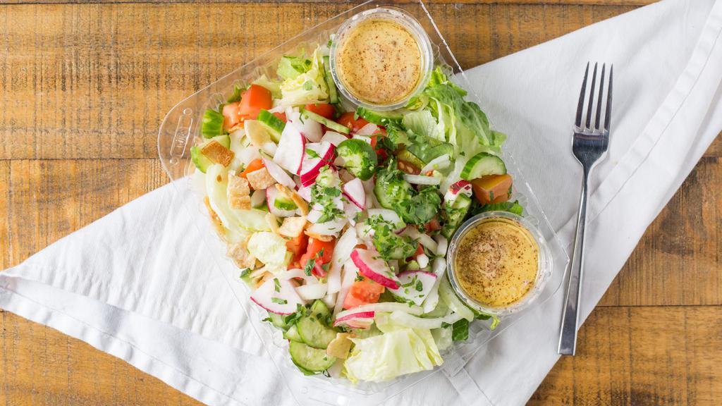 Fattoush Salad · Romaine lettuce, tomatoes, onions, radishes, cucumbers and parsley tossed in our fattoush dressing and topped with pita chips.