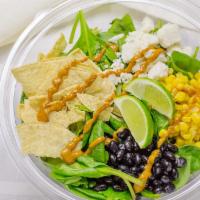 Lime Chipotle Salad · 100 % Plant Based. Spinach, corn, black beans, vegan grated cheese, tortilla chips, lime chi...