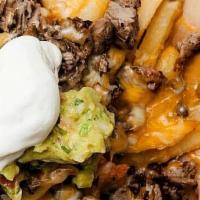 Asada Fries · One meat of your choice, beans, cheese, sour cream and avocado.