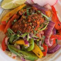 Veggie Taco · Grilled red, green, and yellow bell peppers with onions. Topped with cilantro, onions, and h...