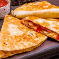Classic Quesadilla · Flour tortilla stuffed with shredded cheese, choice of meat.