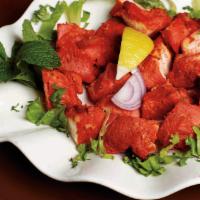 Chicken Tikka · Boneless chicken marinated in yogurt and mild spices and cooked on a skewer in tandoor.