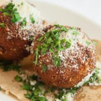 Rice Balls · Two per order with a side of tomato sauce