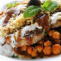 Aloo Tikki Chaat (Veg, G) · Another classic Indian street food. Crisp potato patties topped with cooked chickpeas, chopp...