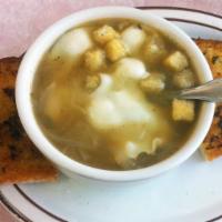 French Onion Soup · Covered with swiss cheese and served with garlic toast.