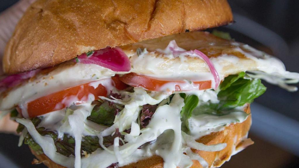 Reel Fish Sandwich · Traditional made with grilled Regal Springs Tilapia, lettuce, tomato, cabbage. Choose your sauce, or pick another daily fish.