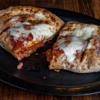 Combo Calzone · Hand-tossed dough stuffed with pepperoni, ham, onions, green peppers, our signature pizza sa...