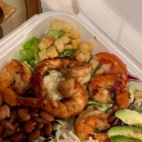 Mexican Shrimp Caesar Salad · Traditional caesar salad topped with bay shrimp, whole beans, shredded cheese, tomatoes, and...