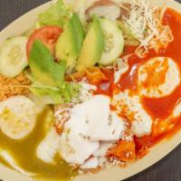 Huevos Divorciados · Two sunny side up eggs covered with red and green sauce. Served with rice, beans and salad.