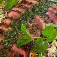 Grilled Flank Steak Thai Salad · Grilled flank steak, veggies, lemongrass, red onions, Thai chili, lemon zest, and herbs.
