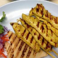 Satay (5 Skewers) · Skewered chicken marinated with Thai herbs & spices, grilled to perfection, served with cucu...