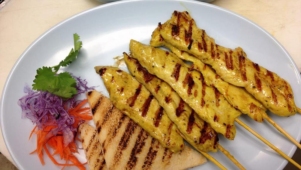 Satay (5 Skewers) · Skewered chicken marinated with Thai herbs & spices, grilled to perfection, served with cucumber salad & peanut sauce.