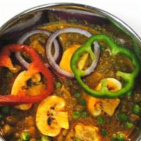 Mushroom Matar · Mushrooms and green peas simmered in a light sauce.