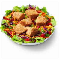 Rotisserie-Style Chicken Bites Salad Bowl · 100% white meat, juicy, tender, rotisserie-style chicken bites, served on top of a crisp bed...