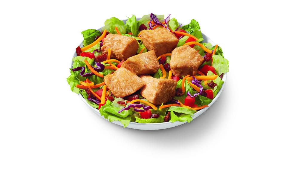 Rotisserie-Style Chicken Bites Salad Bowl · DQ's new 100% white meat, juicy tender, rotisserie-style chicken bites, served on top of a crisp bed of lettuce, diced tomatoes, bacon and shredded cheddar.  Served with house-made Hidden Valley Ranch, or your choice of dressing.