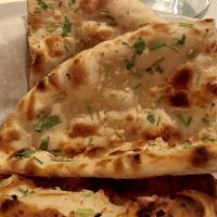 Garlic Naan · Leavened bread garnished with garlic and cilantro, baked in clay oven.