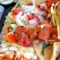 World Famous Fish Taco. · Lightly battered and fried, topped with cabbage, onion, tomato, cilantro, and our signature ...