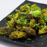 Roasted Brussel Sprouts · Served and tossed with cotija, cilantro, fresh lemon juice and pepita seeds over our secret ...
