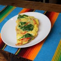 Omelet Ala Mexican · Scramble omelet cooked with tomato,onions,cilantro, bell peppers and topped with cheese.