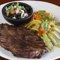 Carne Asada · Savory marinated grilled steak cooked to order. Topped with caramelized onions, cactus slice...