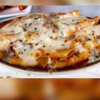 Baked Ziti · Penne pasta tossed in our homemade beef Ragu, baked with shredded Mozzarella cheese.
