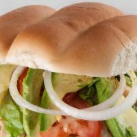Torta Carnitas · Mexican style sandwich filled with beans, carnitas, lettuce, tomato, jalapeños, onion,