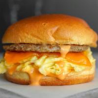 Sausage, Egg And Cheddar Sandwich · 2 fresh cracked cage-free scrambled eggs, melted Cheddar cheese, breakfast sausage, and Srir...