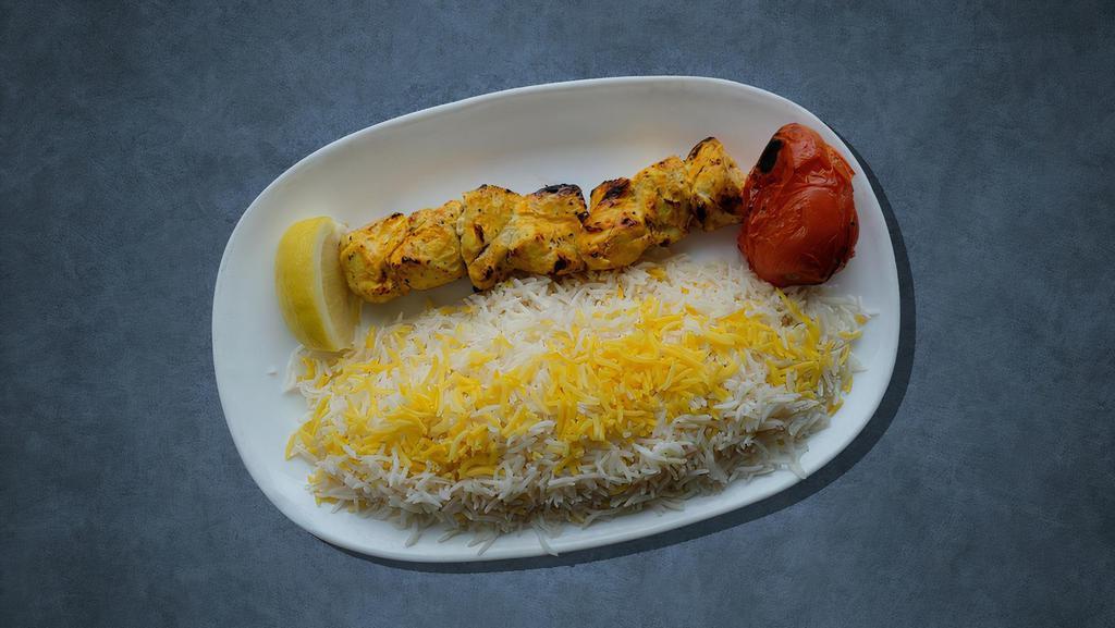 Chicken Kabob Dinner Plate · Two grilled chicken skewers, marinated in garlic and herbs. Served with rice, hummus, salad, pita bread, and garlic sauce.