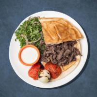 Big B Dinner Plate · Thinly carved marinated beef cooked on a vertical broiler. Served with rice, hummus, salad, ...