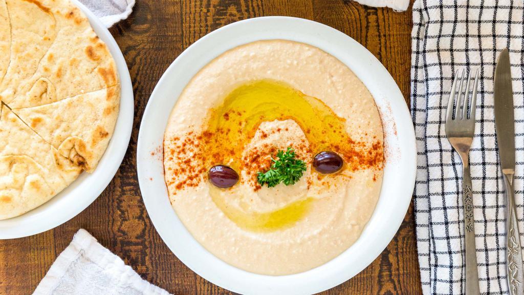 Hummus Dip · This middle eastern dip is a combination of garbanzo beans, sesame tahini, lemon, and garlic. Served with pita bread.