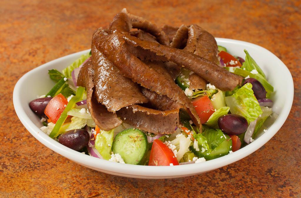 Gyros Salad · Greek salad with gyros meat. Salads come with lettuce, cucumber, onion, tomato, bell pepper, feta and olives. Dressing comes on the side when to-go. Gyros sauce comes on the side.  Choice of pita bread or garlic bread.