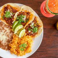 Barbacoa Tacos · Three tender Mexican style barbecue beef tacos. Served with rice, beans, salsa fresca and gu...