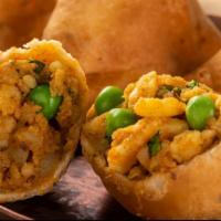 Samosas · 2 fried pastries with a savory filling of spiced potatoes, onions & peas.