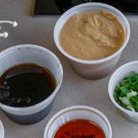 Dipping Sauce Set · Goma, ponzu, chili oil, ground sesame, green onion, & grated radish.