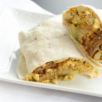Breakfast Burrito · Vegan. Flour tortilla filled with tofu scramble, vegan sausage, potatoes, avocado, Vegan che...