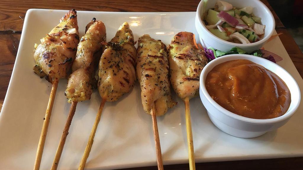 Chicken Satay · Grilled chicken skewers served with cucumber salad and peanut sauce.